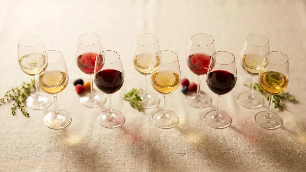 Five pairs of wine glasses each showing a cool-climate and warm-climate version of the same grape variety